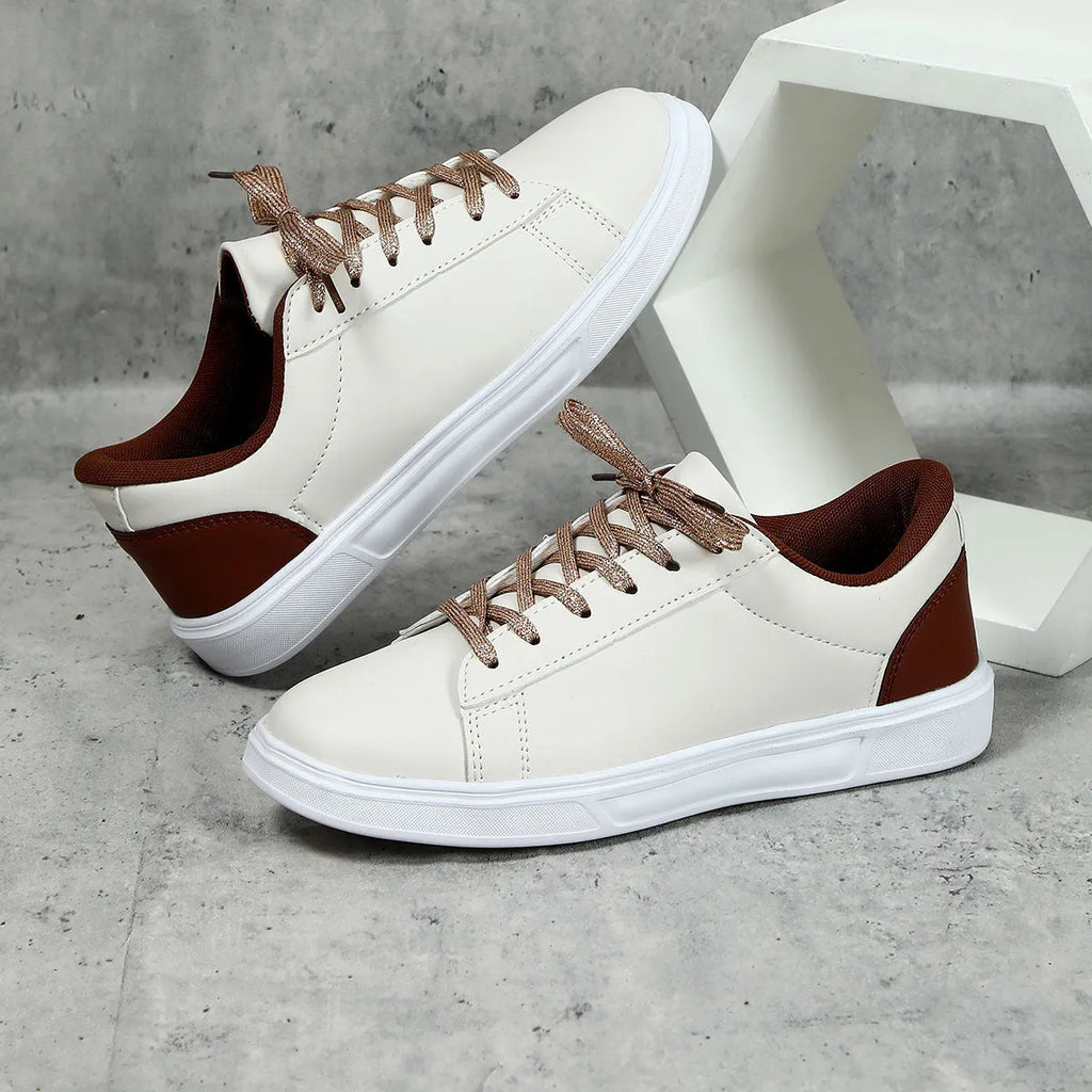 Beige brown casual platform sneakers with cross strap detail and rubber sole.