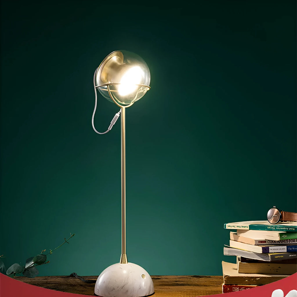Modern desk lamp with a glass lampshade and touch-sensitive base for dimming control.