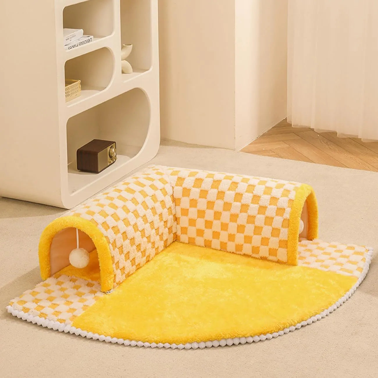 Fan-shaped plush pet bed with central play tunnel in plaid design, shown in coffee colour.
