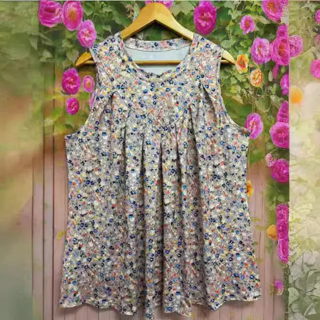 A woman's plus-size black sleeveless vest with a floral print, featuring a round neck and loose fit.