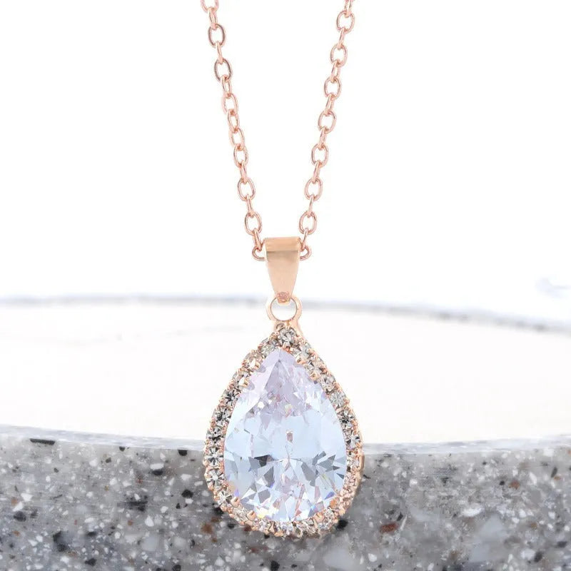 Pink drop shape women's necklace with geometric pendant design and rhinestone details