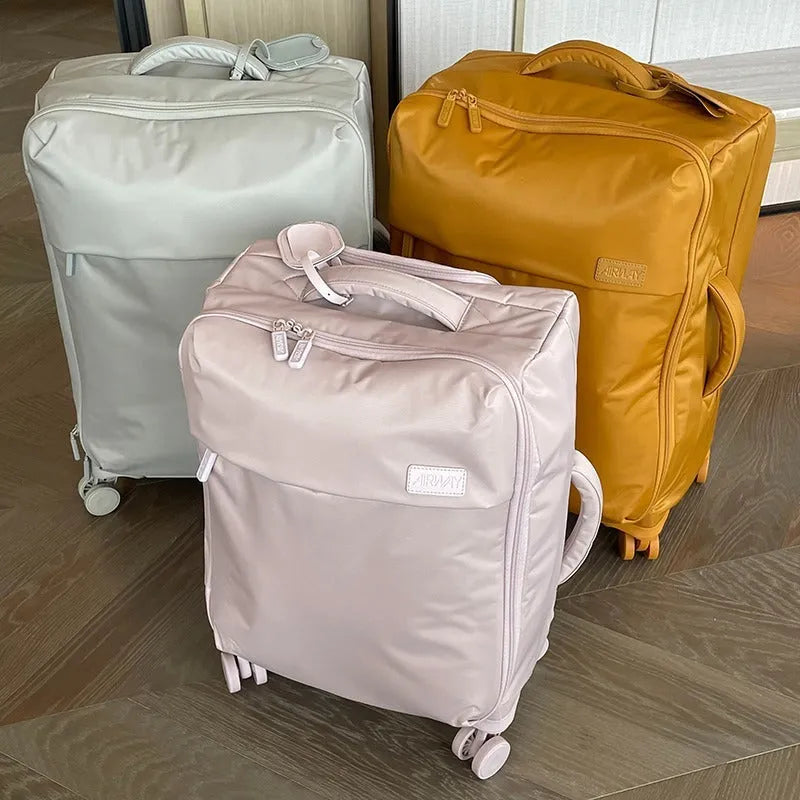 Ultra-light waterproof Oxford cloth suitcase in bluestone green with universal wheels, 20-inch size shown.