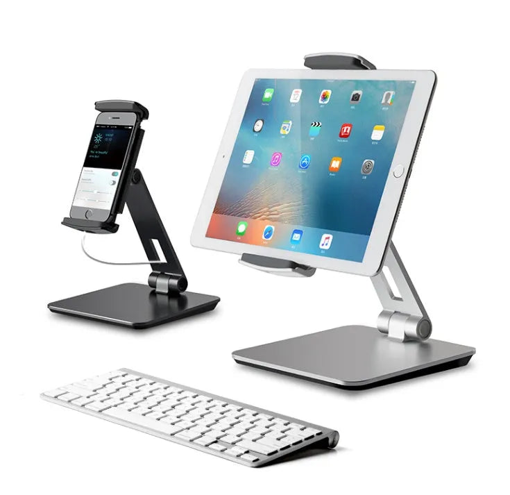 Black folding aluminium desktop stand holding a tablet at an angle, showing 360° rotation and silicone grips.