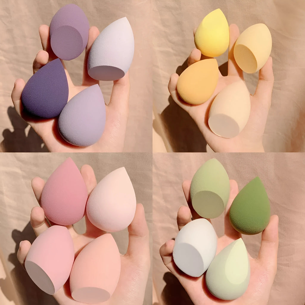 Box containing four coloured makeup egg sponges in Grape, Mango, Mint, and Peach.