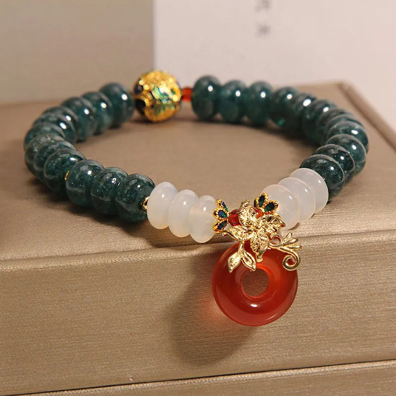 Women's blue water jade and red agate crystal bracelet with peace buckle closure