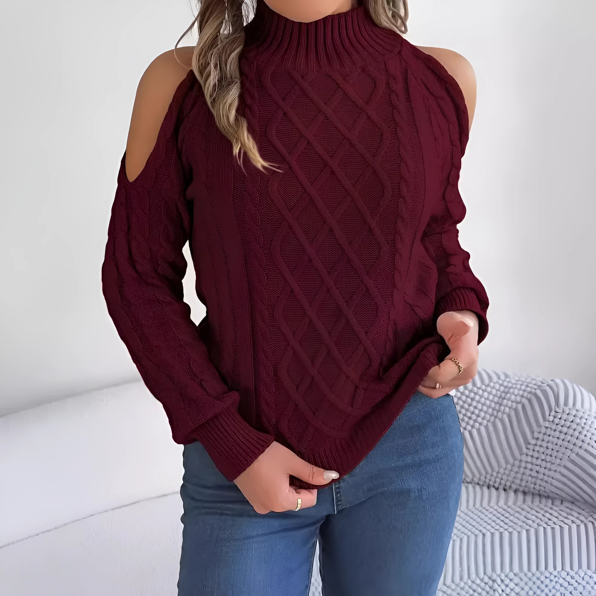 Gray women's acrylic sweater with a twisted knit pattern, half-high collar, and long lantern sleeves on a hanger.