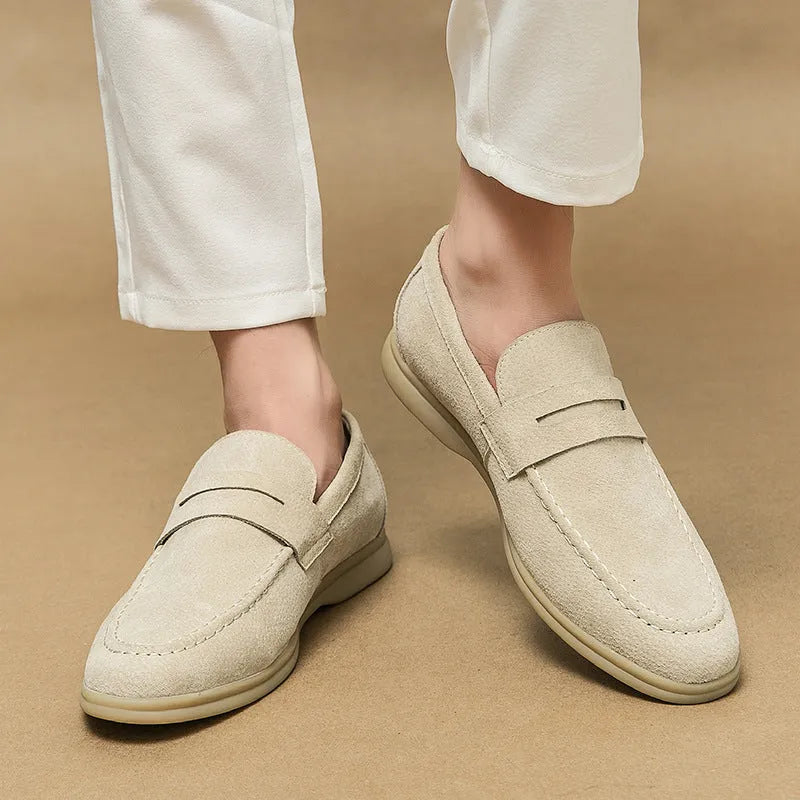 Men's black leather slip-on shoes with round toe and oversleeve design on a rubber sole