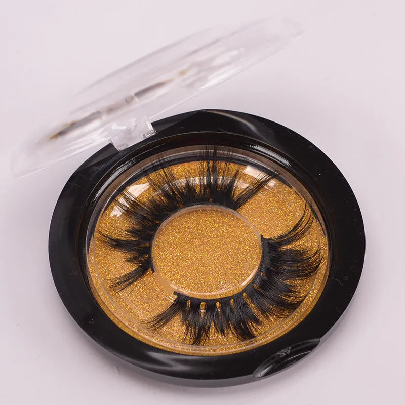 5D mink false eyelashes set with hair storage cap and double-headed brush on a clean surface.