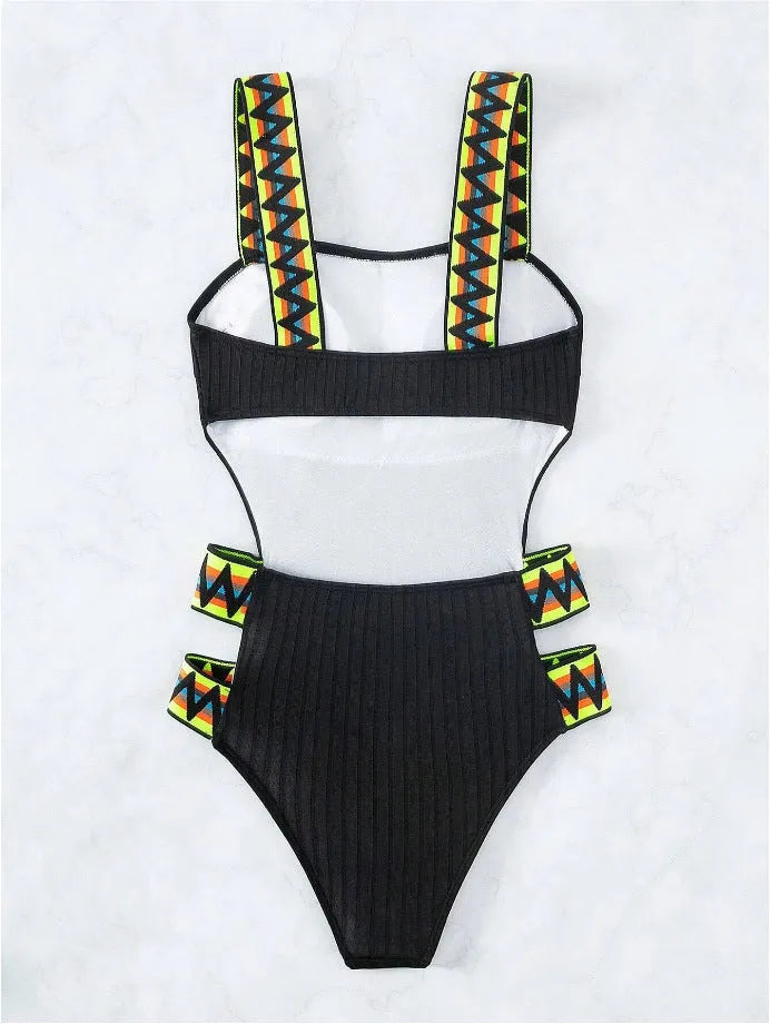Women's solid black one-piece polyester swimsuit laid flat, showing its simple design.