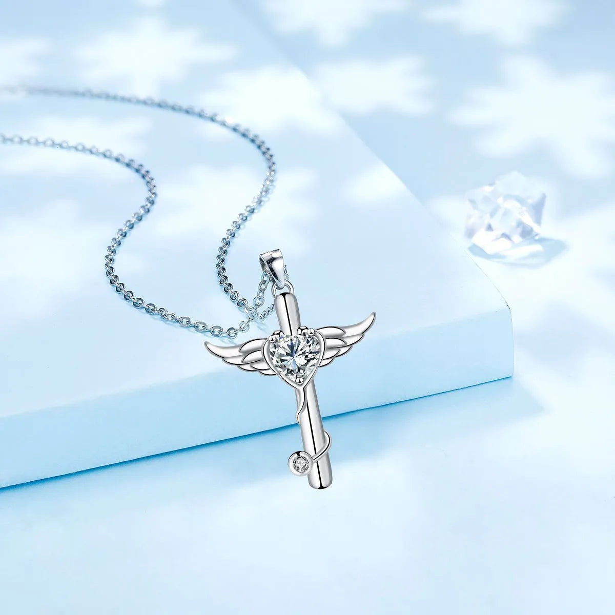 Stethoscope-shaped copper necklace with wing design elements in electroplated red or white diamond finish