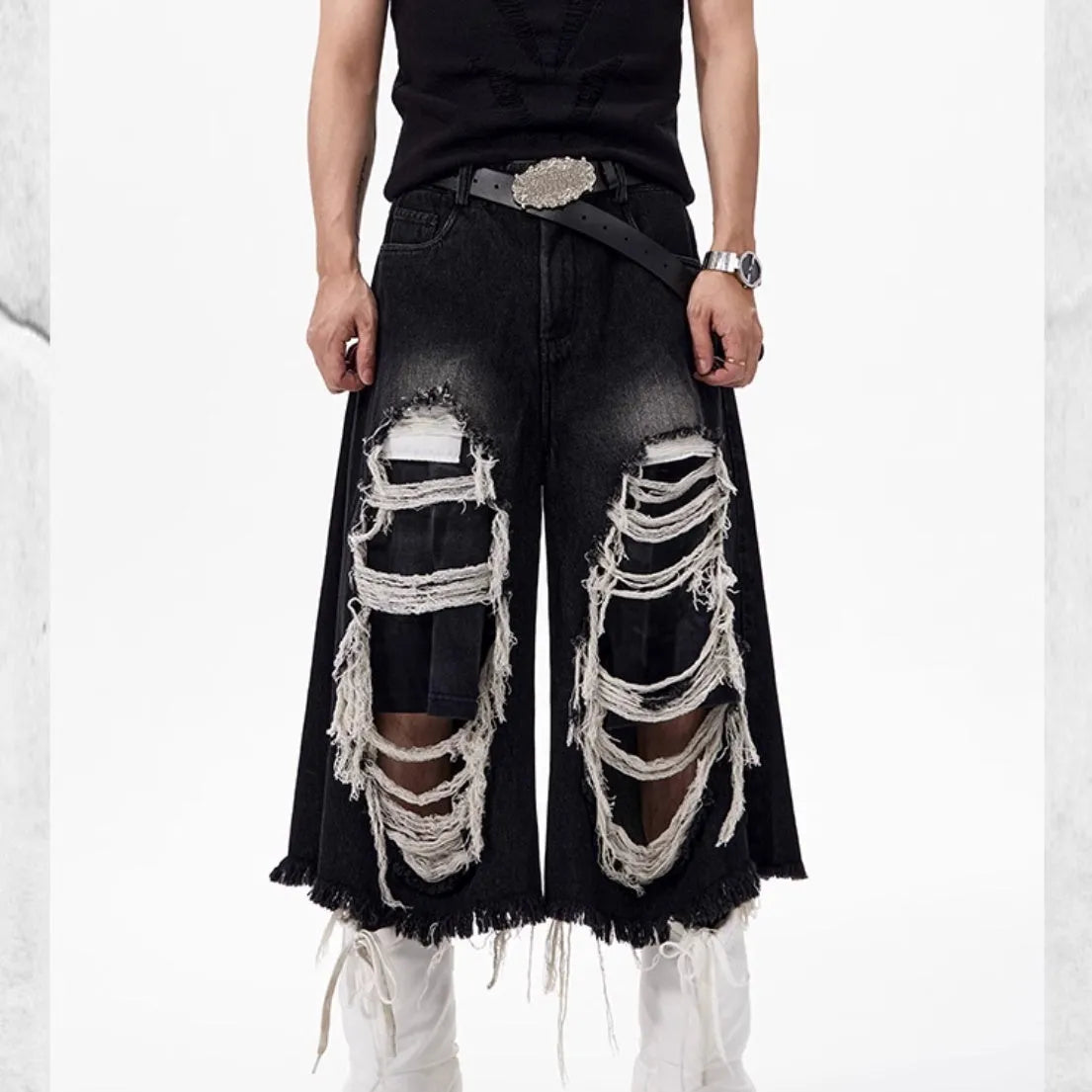 Black loose fit wide leg cropped jeans with a mid-high waist on a model.
