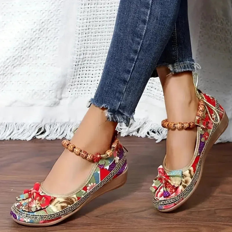 Women's black plus size ethnic platform sandals with elastic band fastening.