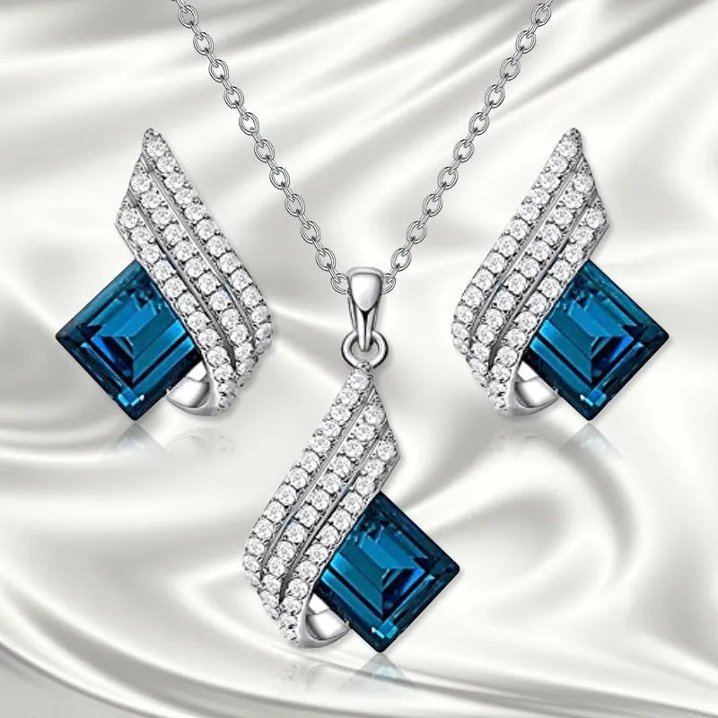 Women's necklace and earring set with a glass pendant on an electroplated alloy cross chain.