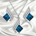 Women's necklace and earring set with a glass pendant on an electroplated alloy cross chain.