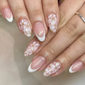 Removable short almond nails with French style finish and glitter flower decoration in colour C625