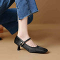 Women's black square toe stiletto heel ankle-strap shoes with horse hair upper and buckle closure.