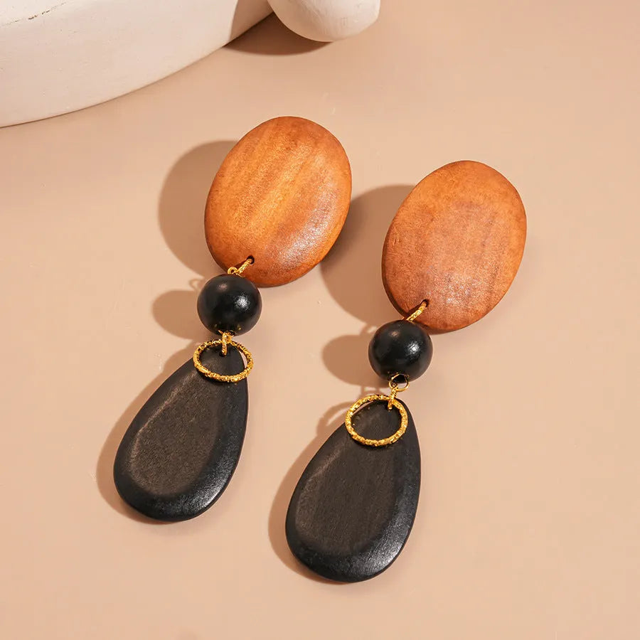 Brown-black wooden elliptical earrings with retro European-American style and silver needle detailing