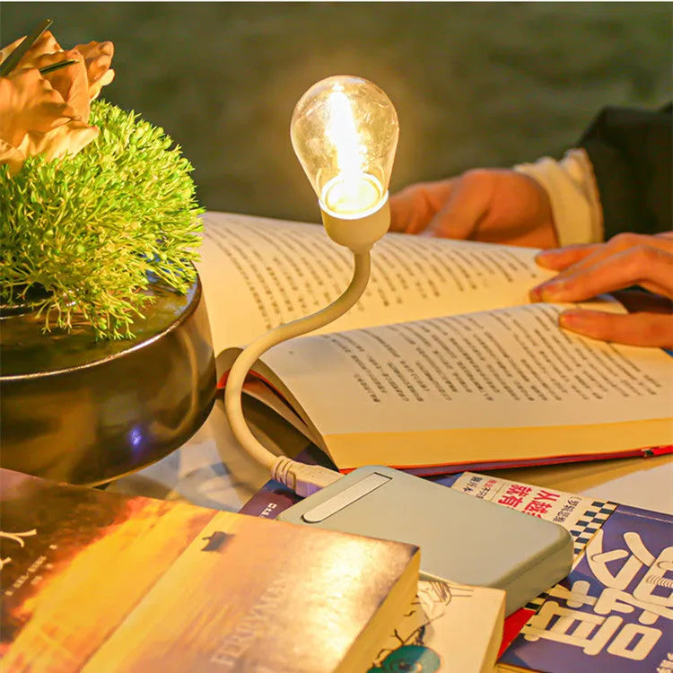 A folding USB rechargeable night light with a warm white tungsten filament S14 bulb visible.