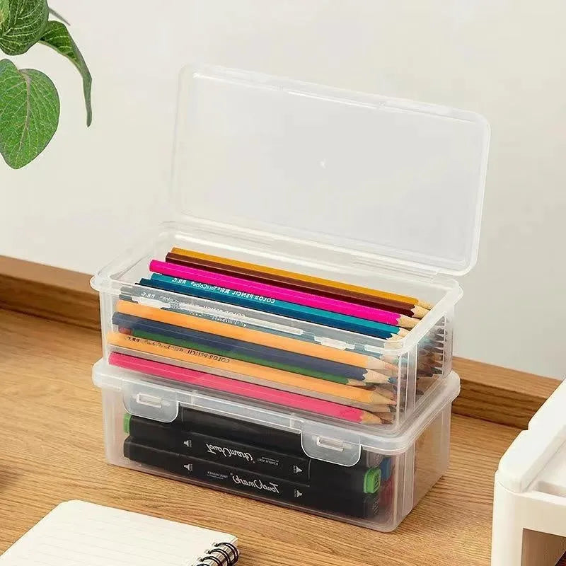 Transparent plastic pencil storage box full of coloured pencils and crayons