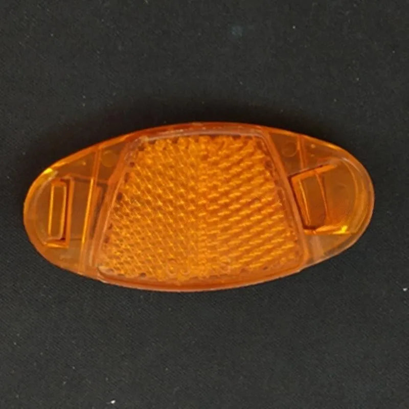Yellow and white plastic bicycle spoke reflectors showing size of 7.2cm by 3.5cm.