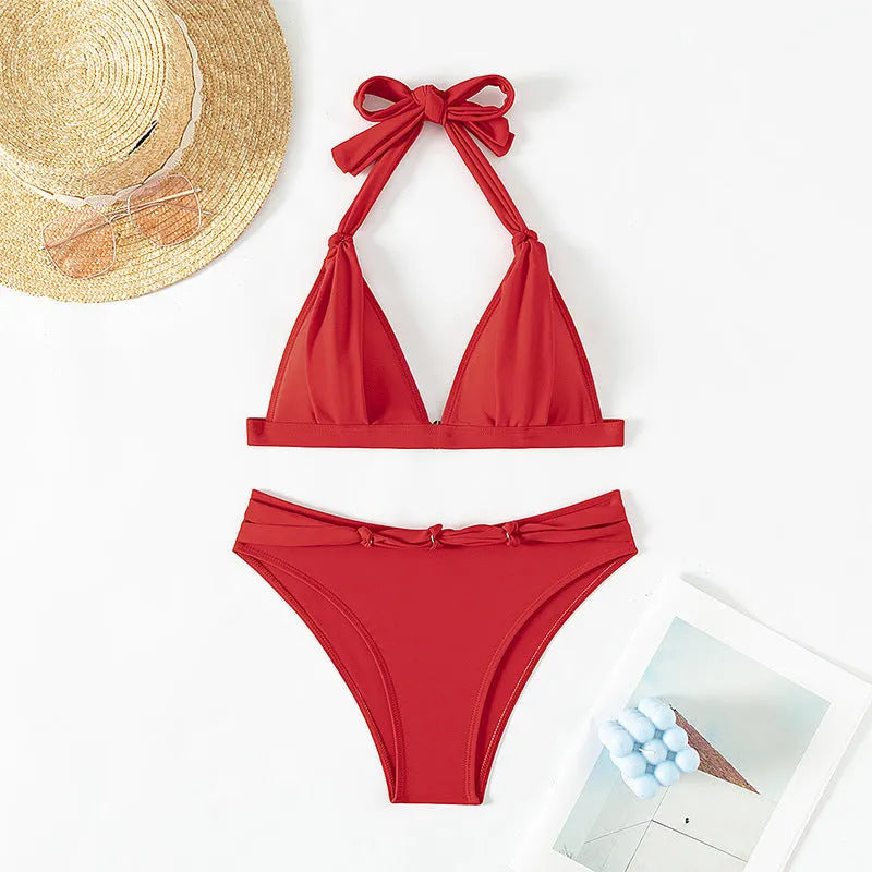 Red women's halterneck lace-up bikini with split shorts for swimming