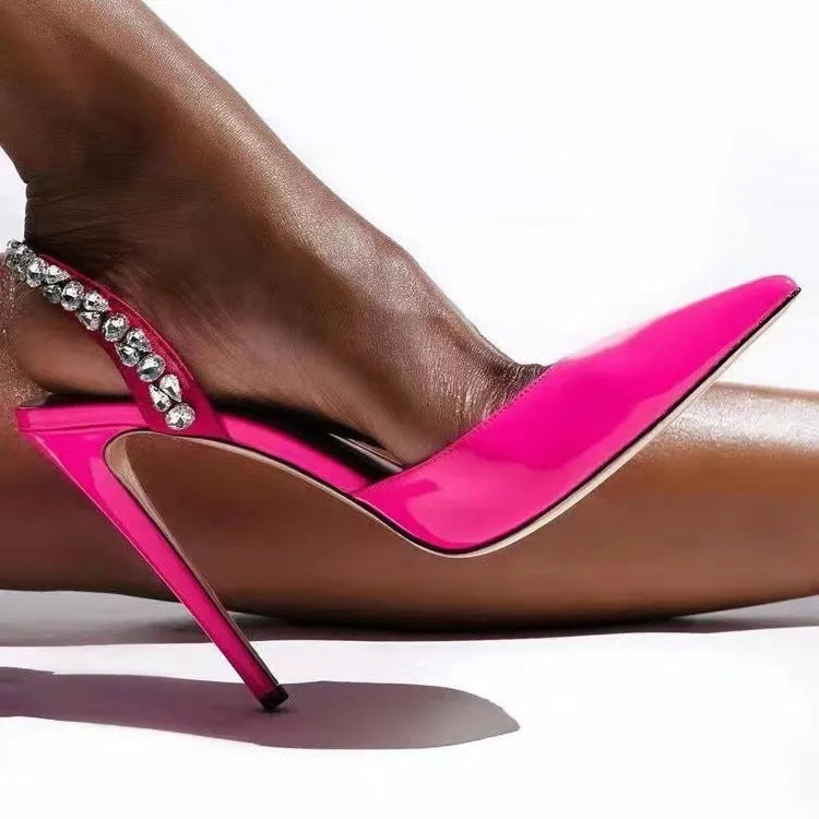 Women's black patent leather pointed toe stiletto sandals with rhinestone detail on the side, shown on a white background.