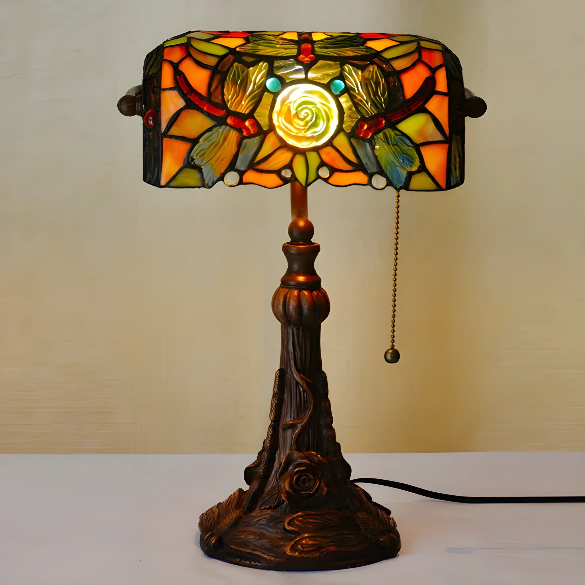 10-inch Tiffany table lamp with stained glass design and resin base on wooden desk