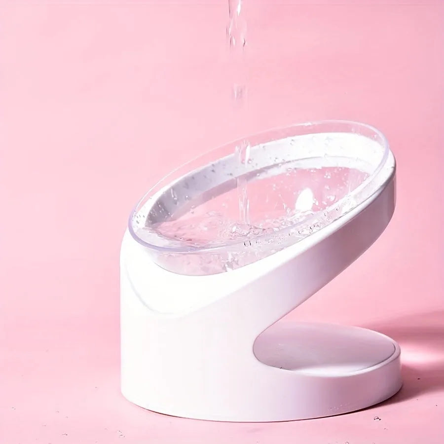 White elevated tilted plastic cat food bowl for ergonomic feeding.