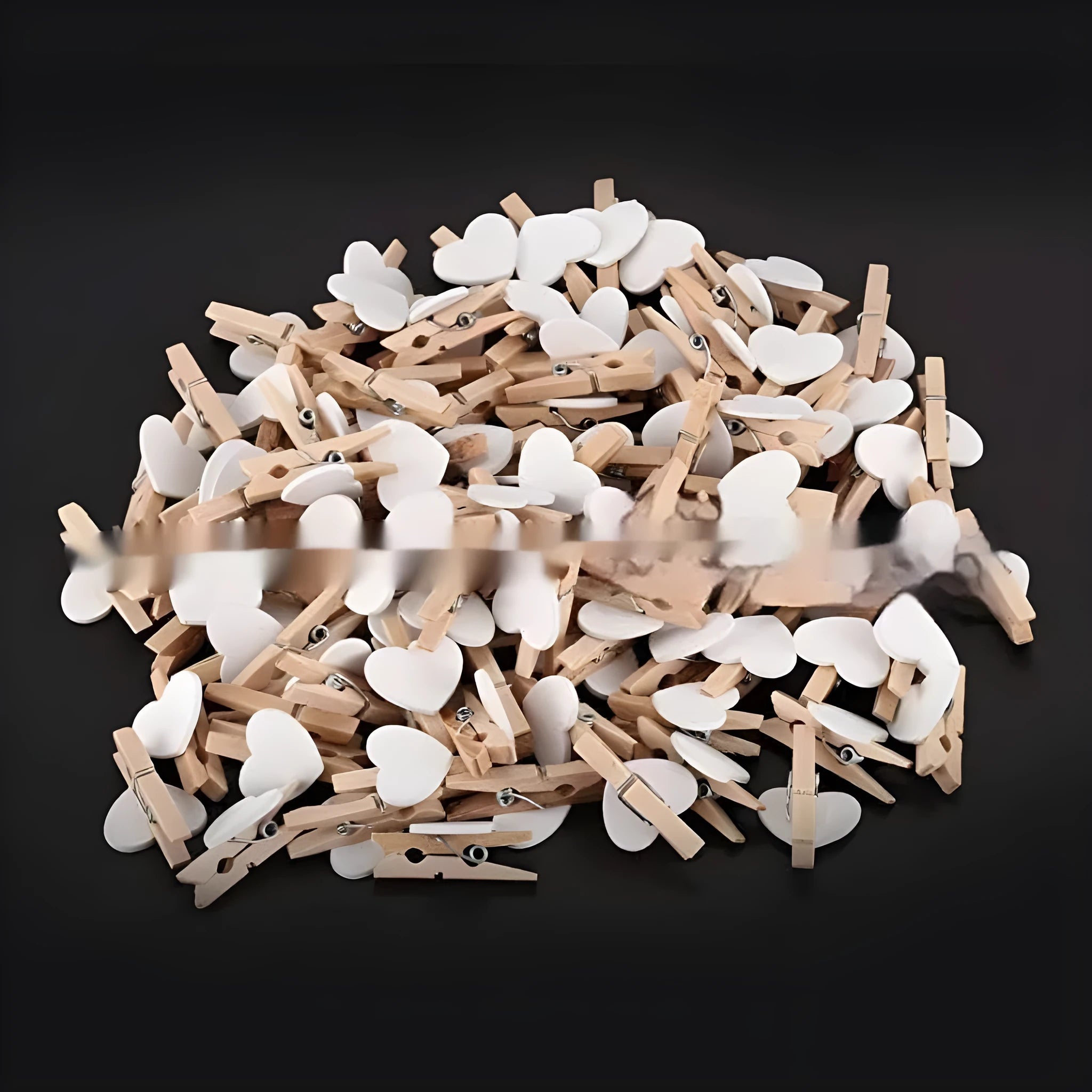 Set of five handmade solid wood heart-shaped clips in red, white, and rose red on a plain surface.