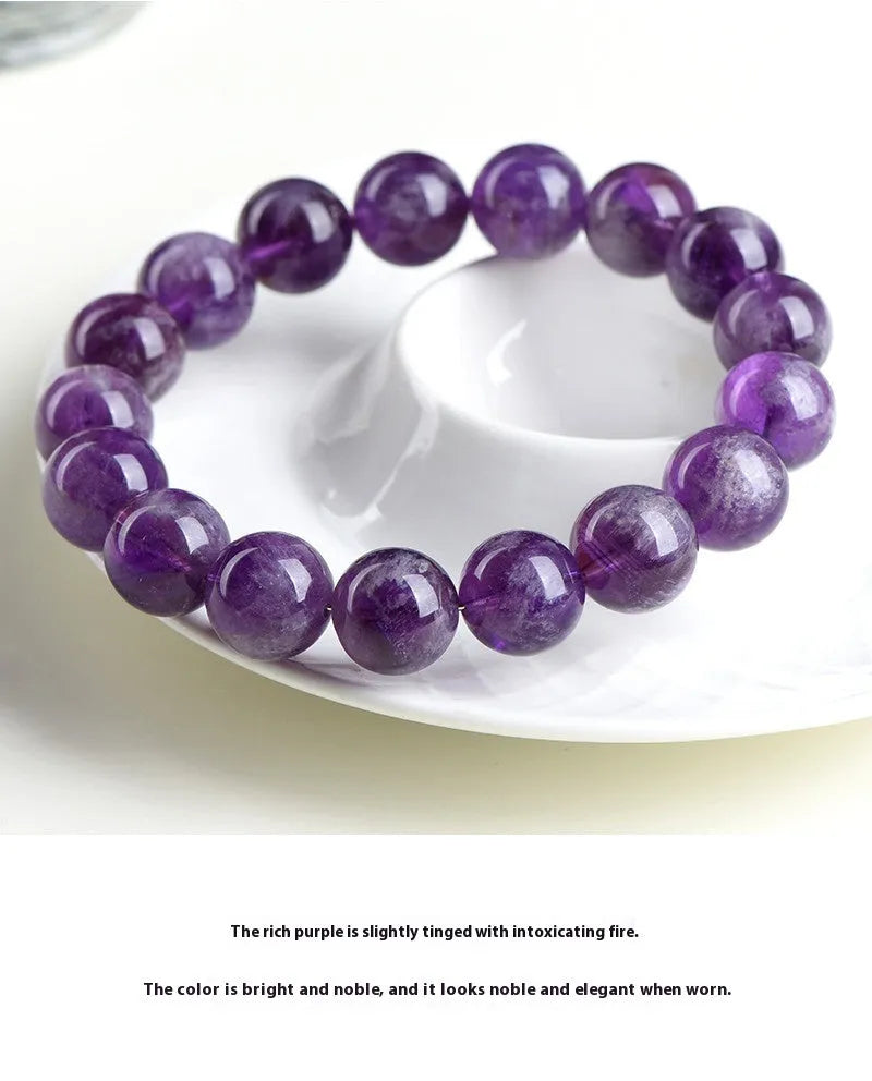 Natural Feather Amethyst Ruyi crystal bracelet with scattered geometry beads on a wrist.