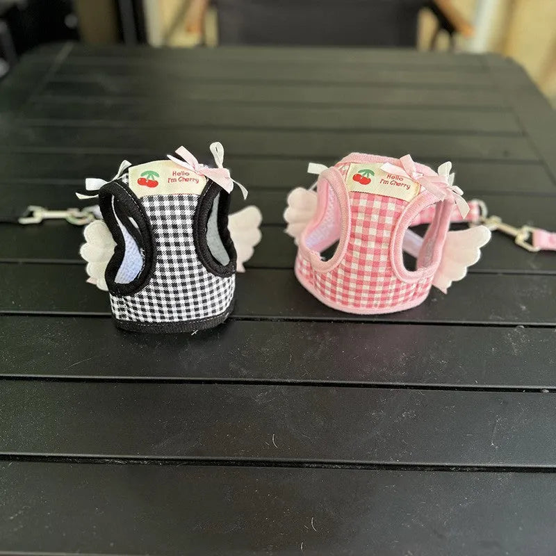 Small dog wearing pink cotton chest and back harness with integrated hand holding rope