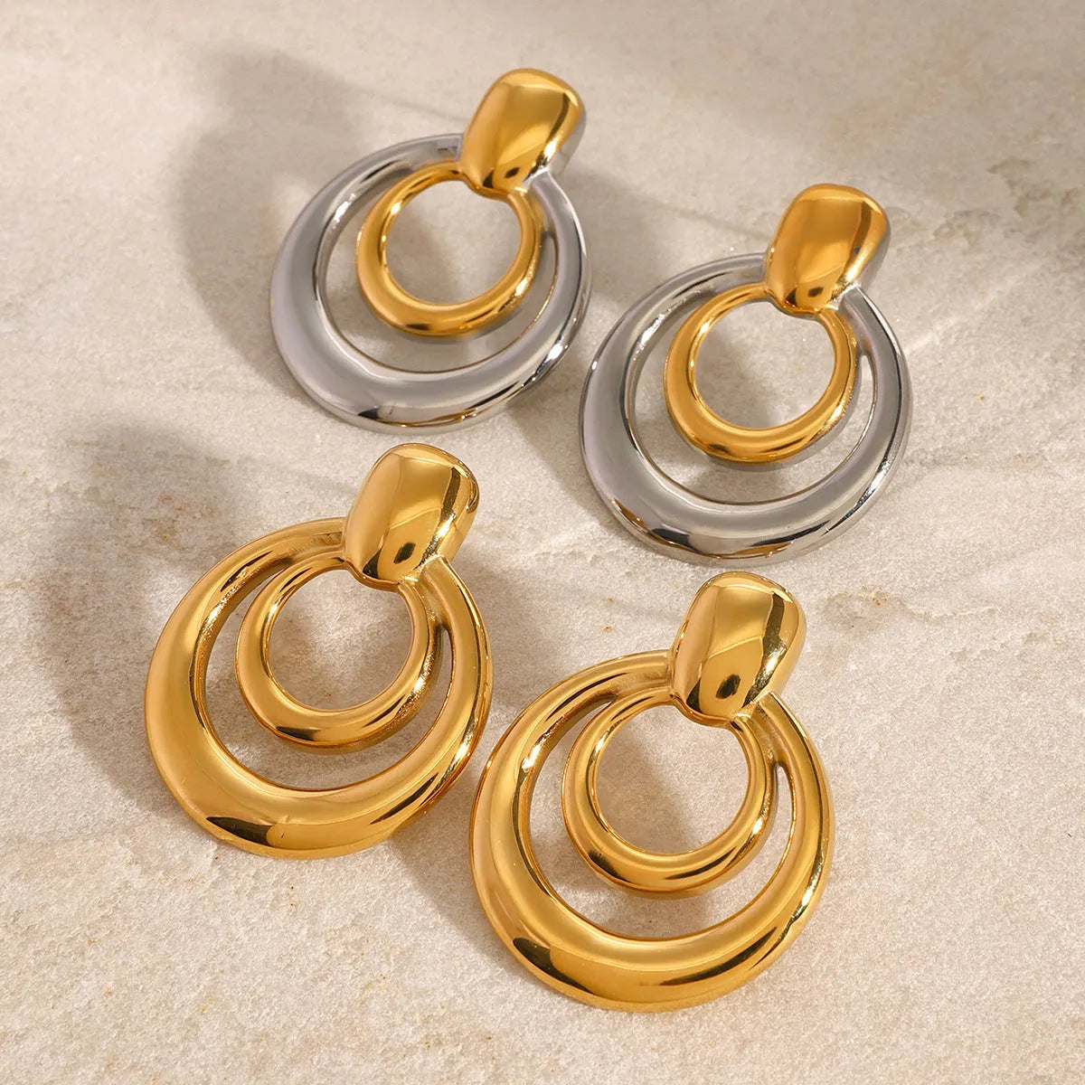 Golden round double layer hollow stud earrings with geometric design and electroplated finish