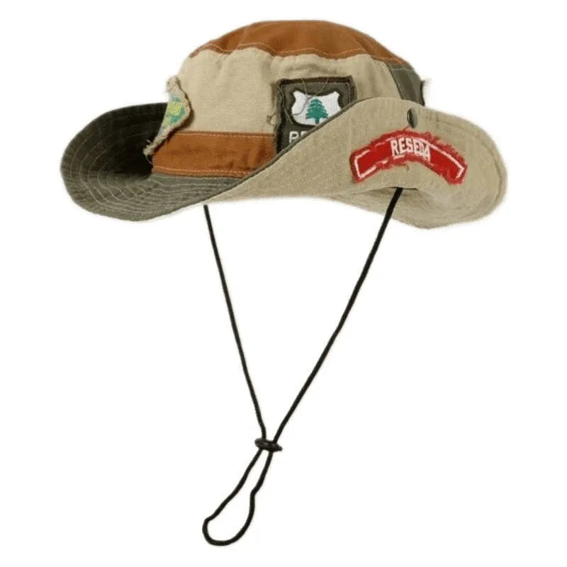 Army green cotton fisherman hat with patchwork detail and flat top crown on a neutral background.