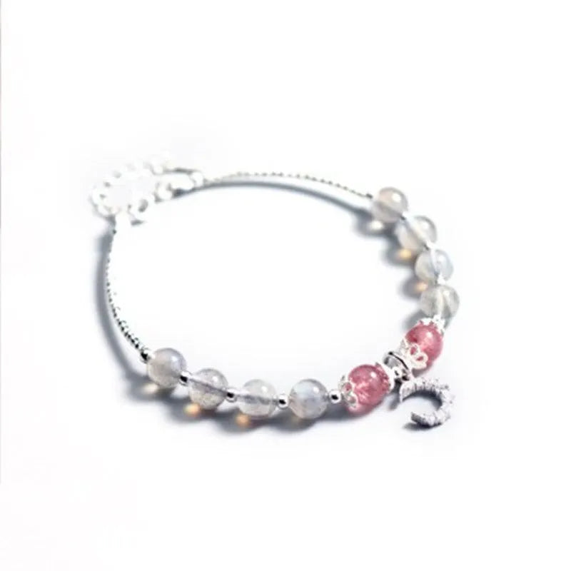 Handmade silver-tone adjustable bracelet with a moonstone bead and crescent moon charm.