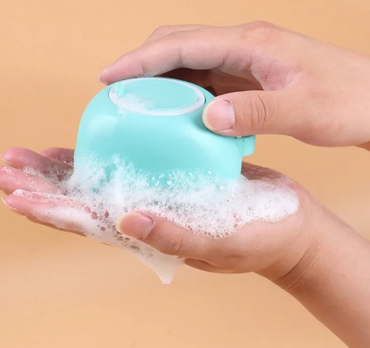 Blue silicone dog bath brush with finger loop and soft bristles for pet grooming