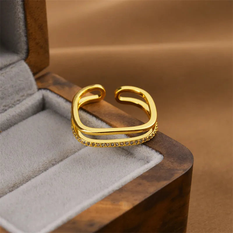 Korean fashion women's open geometric ring in electroplated gold colour on a plain background.
