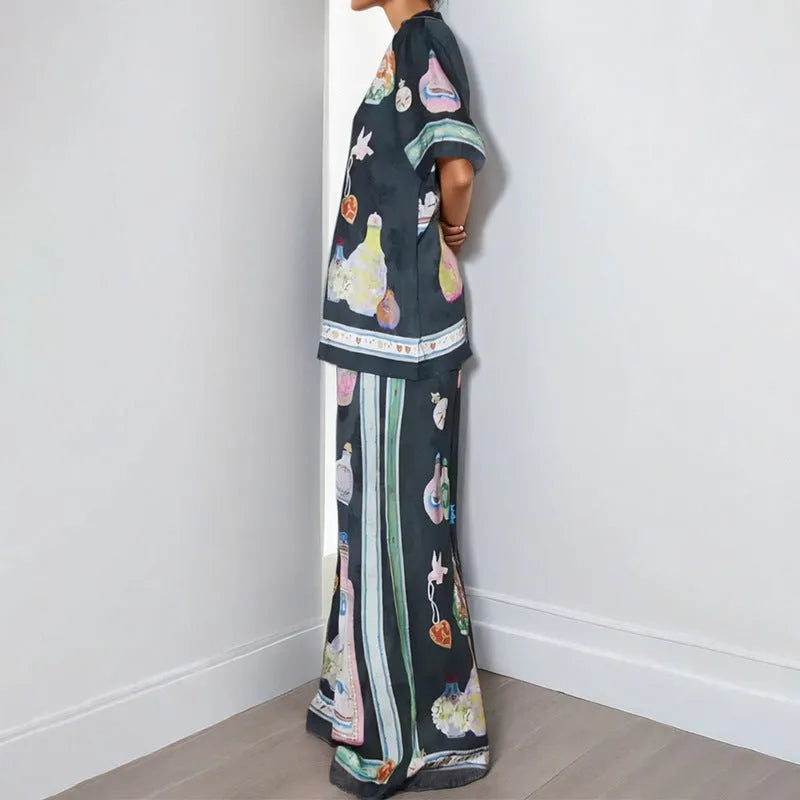 Black women's cardigan and trousers co-ord set with a cartoon pattern print.