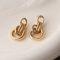 A pair of gold-coloured geometric earrings with an irregular, high-profile wild design for women.