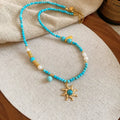 Freshwater pearl necklace with a geometry-shaped stone sun pendant on an electroplated chain.