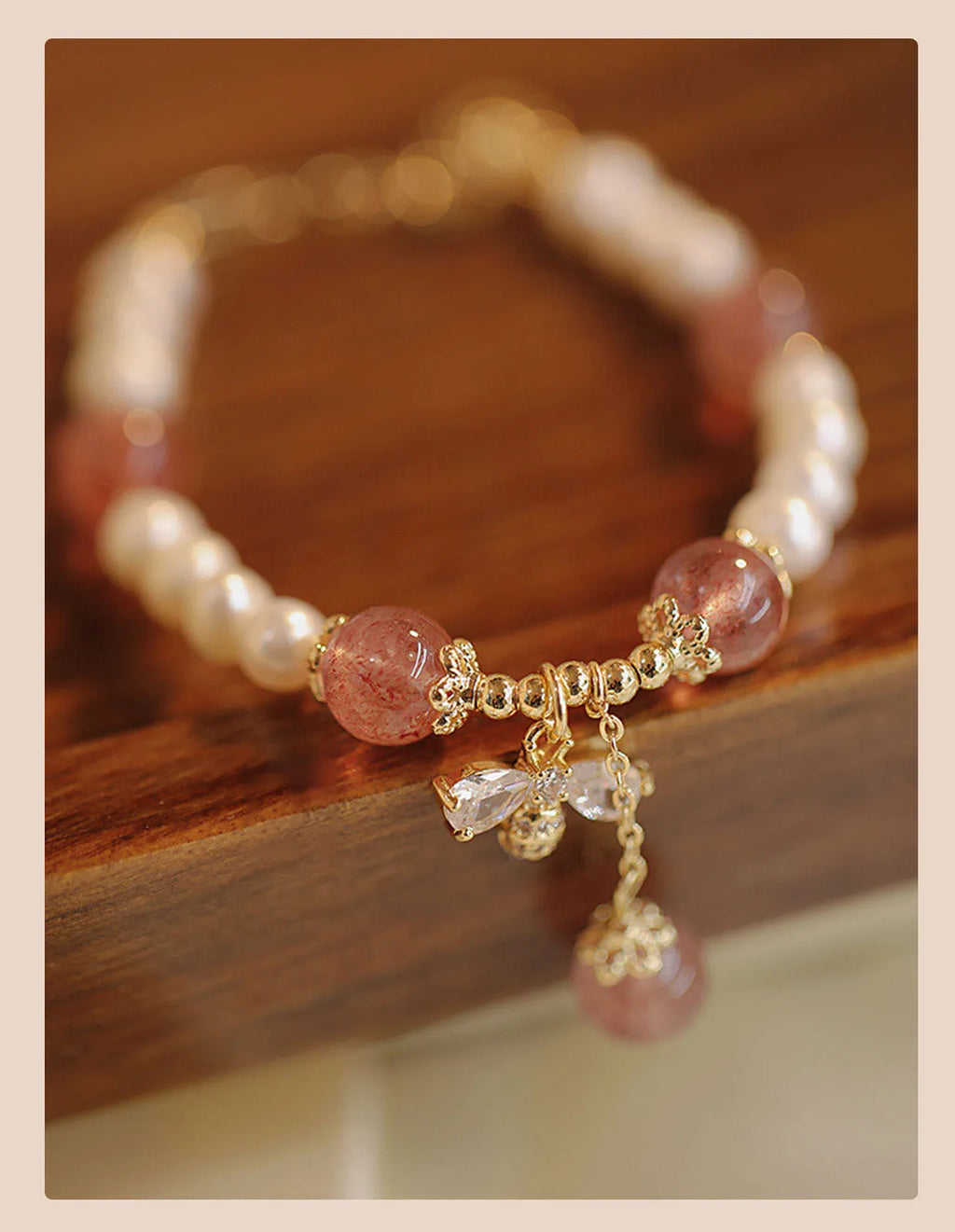 Strawberry quartz colour crystal bracelet with bow and stringed pearls.