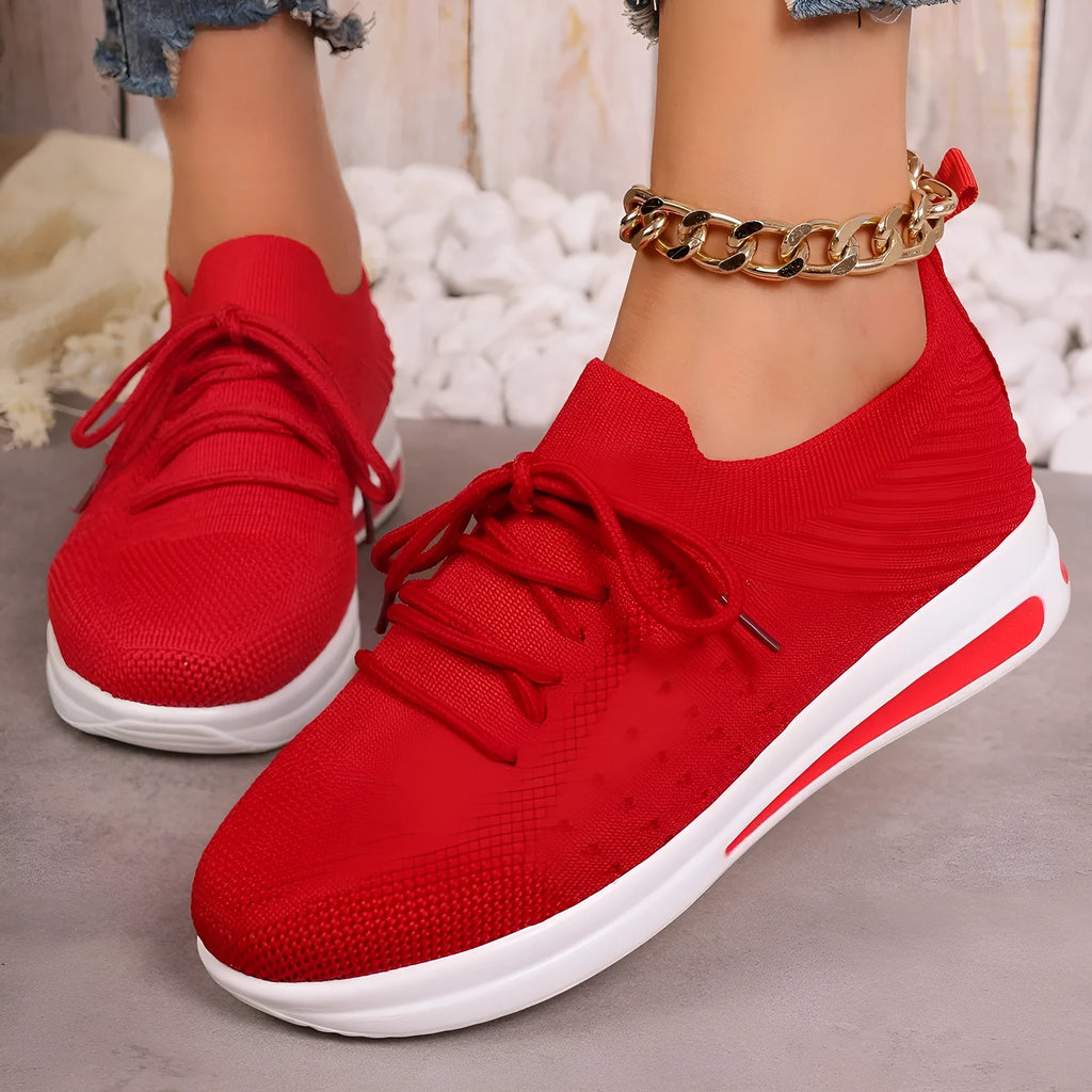 Women's low-top sneakers in black with fly-knit PU upper and front lace-up design.