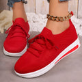 Women's low-top sneakers in black with fly-knit PU upper and front lace-up design.
