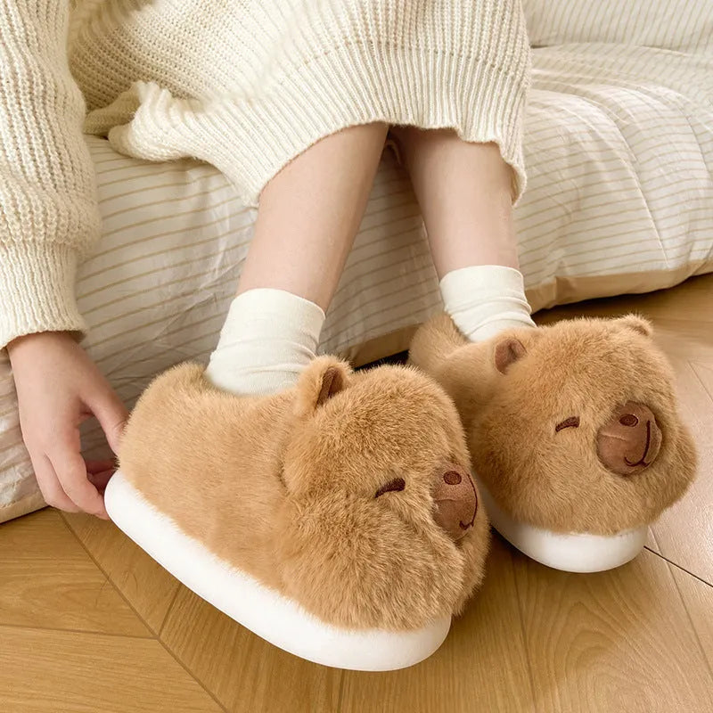 Light brown women's winter slippers with a cartoon pattern, plush upper, and round toe.