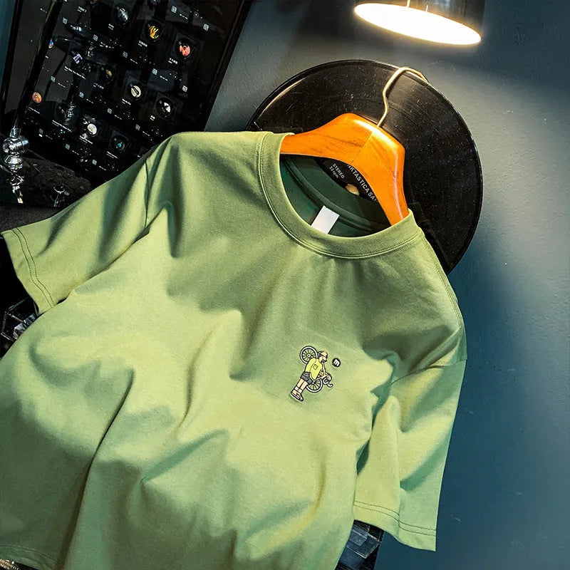 Green men's loose-fit T-shirt with a printed Literary Youth graphic on the front.