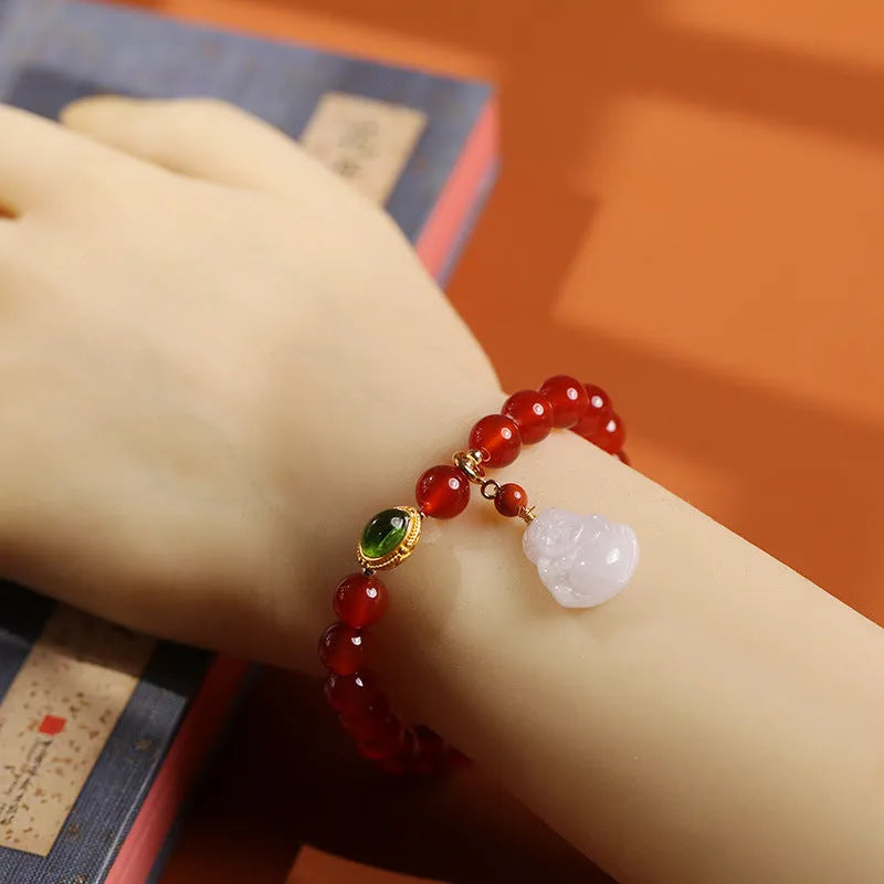 Handcrafted women's bracelet with red agate stone, amber beads, jade and Buddha pendants.