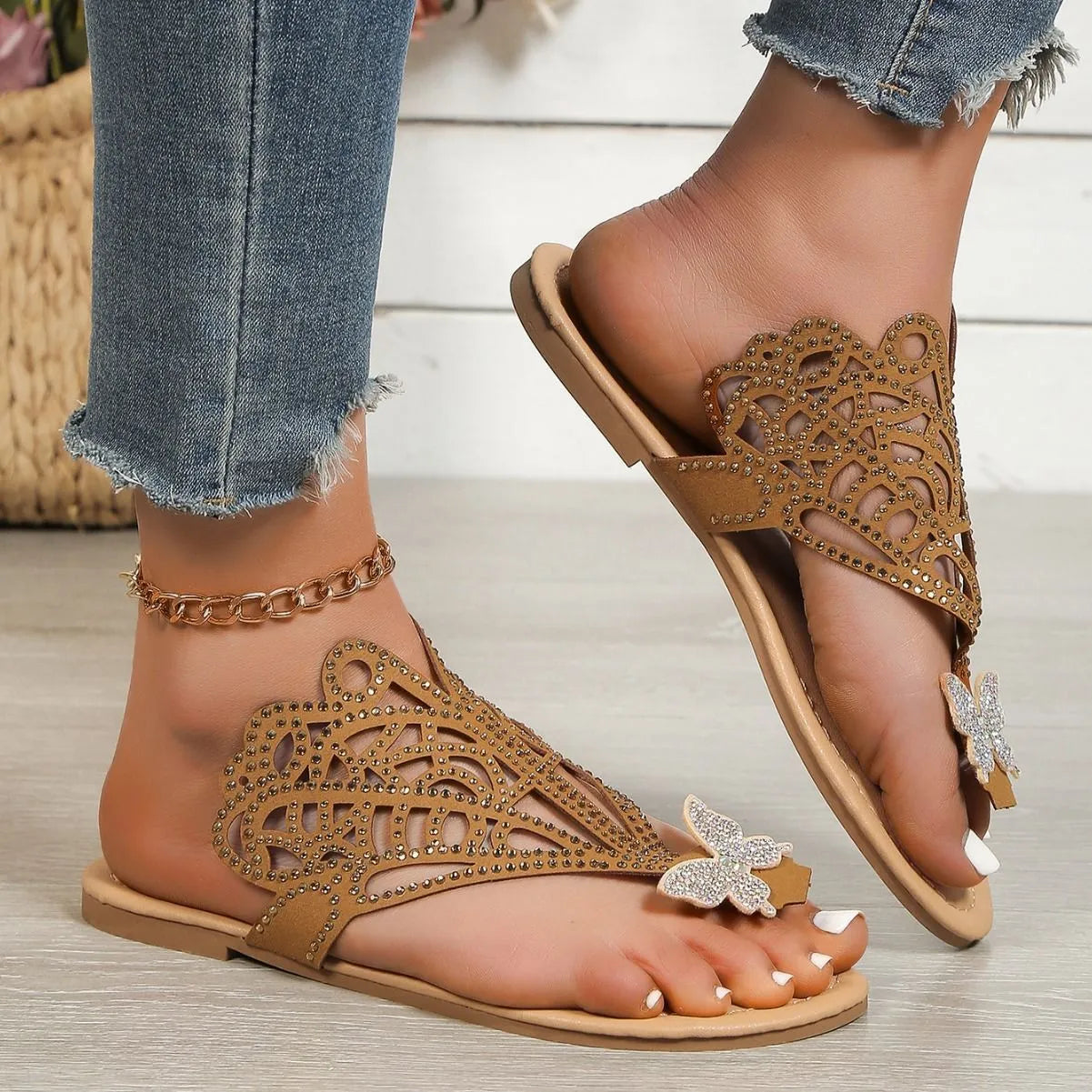 Women's black slip-on sandals with rhinestone details on flip-toe hollow design.