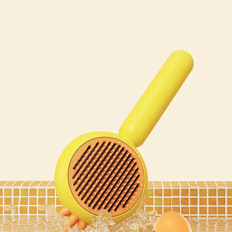 Purple pet grooming brush with stainless steel bristles and self-cleaning button