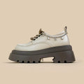 White platform Mary Jane shoes with chunky heel and front lace-up, featuring XINGX bear design.