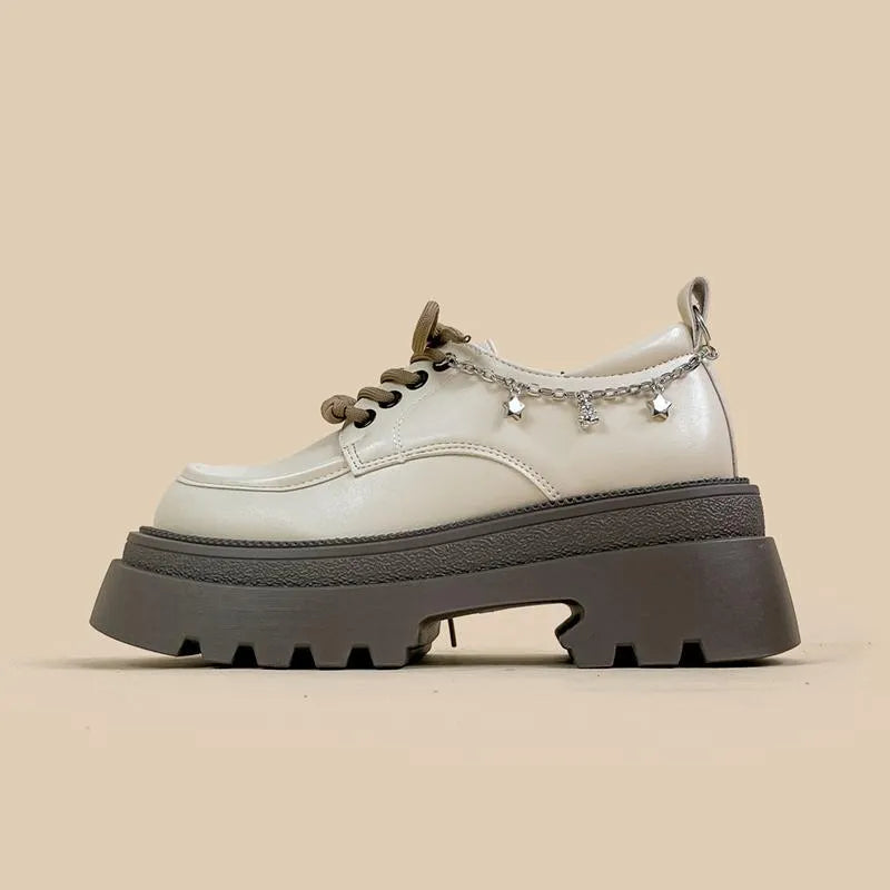 White platform Mary Jane shoes with chunky heel and front lace-up, featuring XINGX bear design.