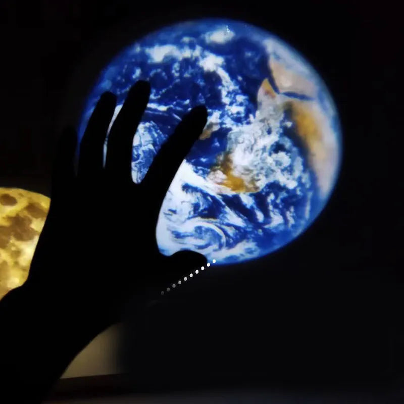 Earth and moon projection lamp with adjustable bracket on wooden surface